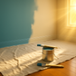 make the drop cloth longer by starting it in the corner and making it extend out of view. Remove the four brushes on the floor. leave just the one on top of the paint can.